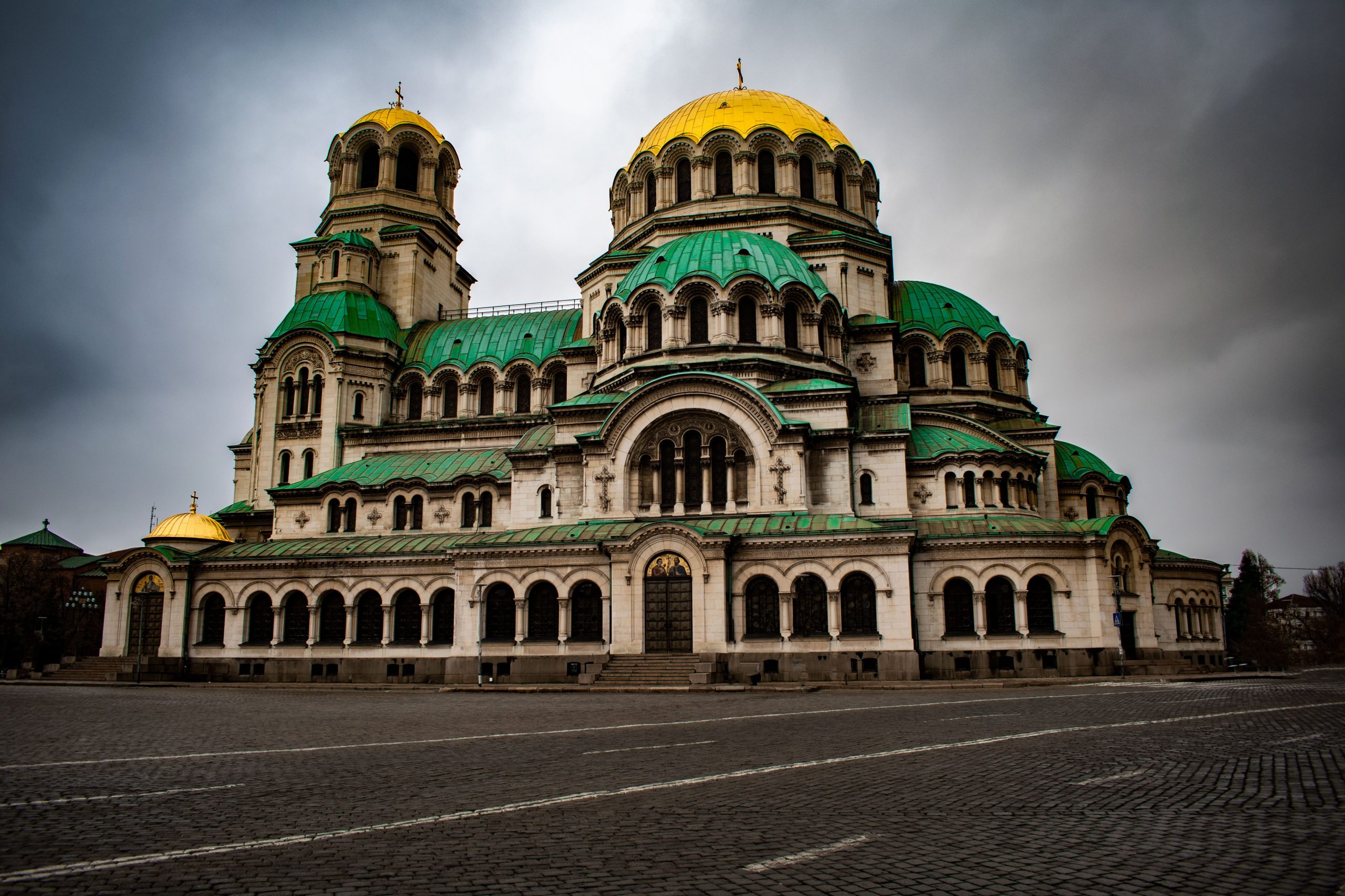 Stunning view of Alexander Nevsky Cathedral with a dramatic, cloudy sky in Sofia, Bulgaria.